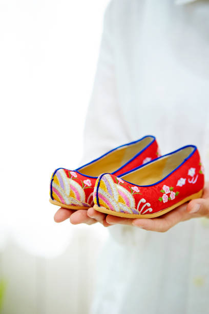 korean woman holding traditional korean shoes